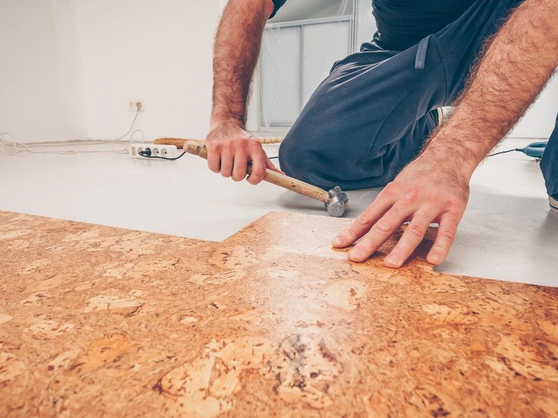 person installing cork flooring from Wilmington Carpets in the Wilmington, OH area